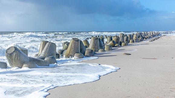 sea landscape with huge waves breaking a poller in Sylt, Germany