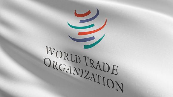 Flag of The World Trade Organization or WTO. Intergovernmental organization that is concerned with the regulation of international trade between nations. 3D rendering illustration of waving sign.